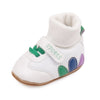 White baby booties with a knit cuff and colorful accents, featuring anti-slip soles.