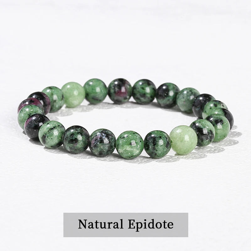 A bracelet made of natural epidote beads in various shades of green and pink.