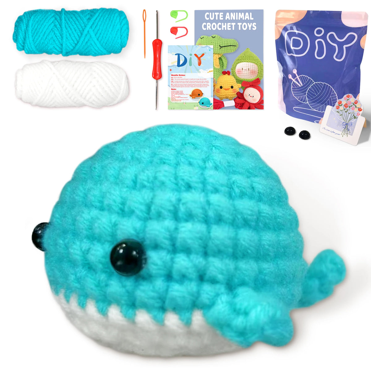 A handmade turquoise whale amigurumi toy made from yarn, shown next to the crochet kit components.