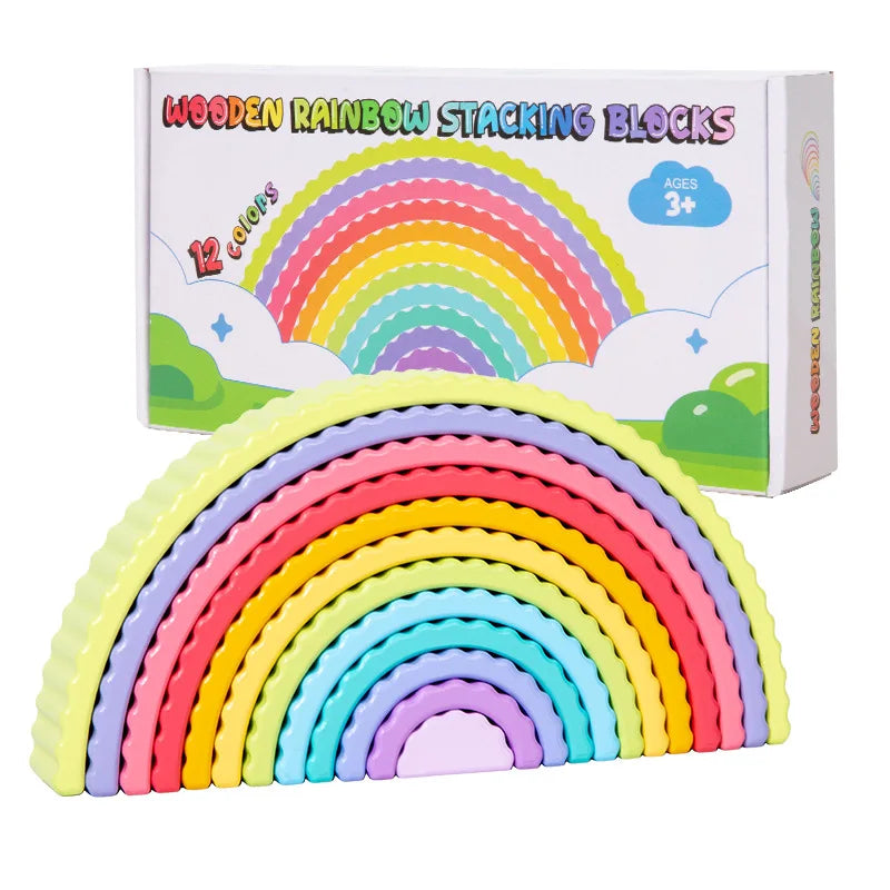 A set of 12 colored wooden rainbow stacking blocks in various pastel colors.