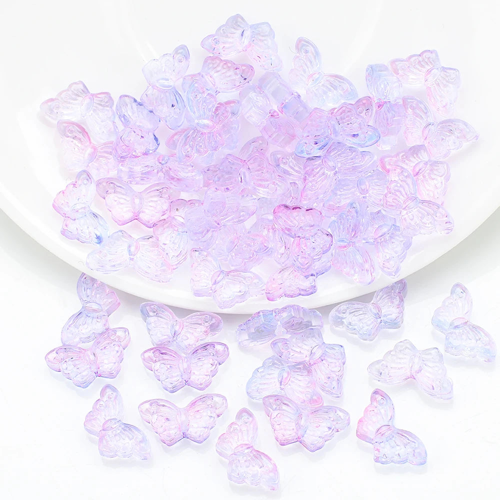 A pile of translucent purple and pink butterfly glass beads for jewelry making