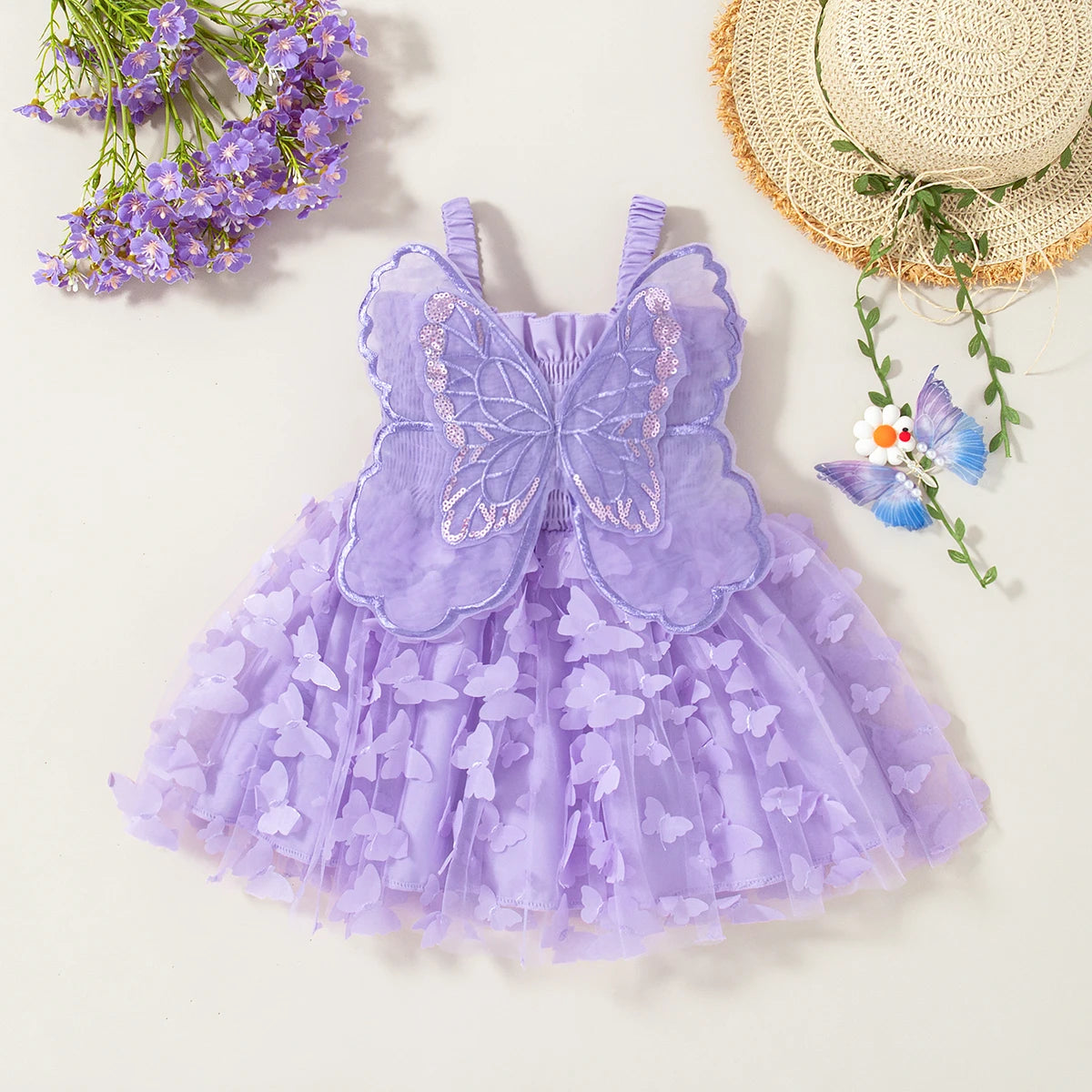 A purple princess-style butterfly suspender dress for baby girls with sheer fabric and floral accents.