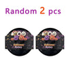 Two black containers of Halloween mystery squishy fidget toys including glitter pumpkin, eyeball, and skull stress relief bal