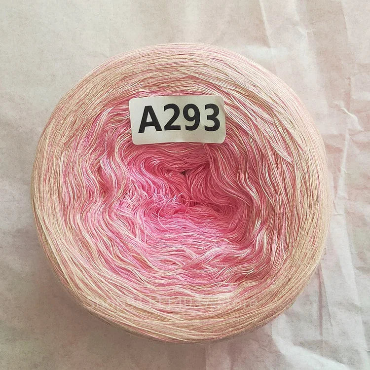 A spool of pink and white rainbow gradient mercerized cotton cake yarn labeled A293