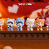 A collection of cute cat mini figurines in various colors and poses displayed on a wooden surface.