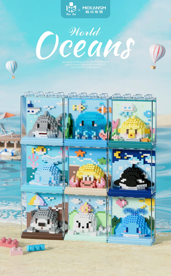 A set of clear building blocks featuring mini models of ocean animals like sharks, dolphins, and whales on a sandy background