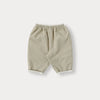 A pair of beige knit sweater and pants set for a toddler.