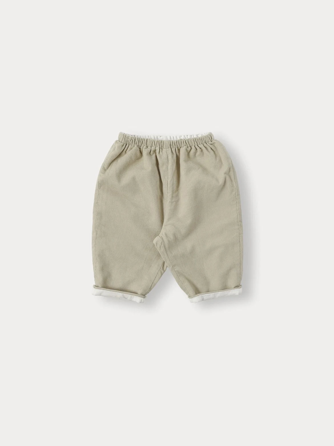 A pair of beige knit sweater and pants set for a toddler.
