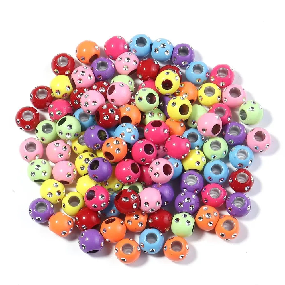 A collection of colorful rhinestone acrylic spacer beads in various shades and sizes.