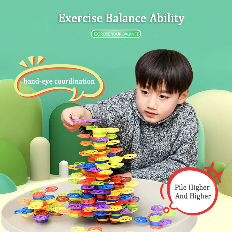 A child is stacking colorful rainbow blocks into a tower to exercise hand-eye coordination and balance ability.