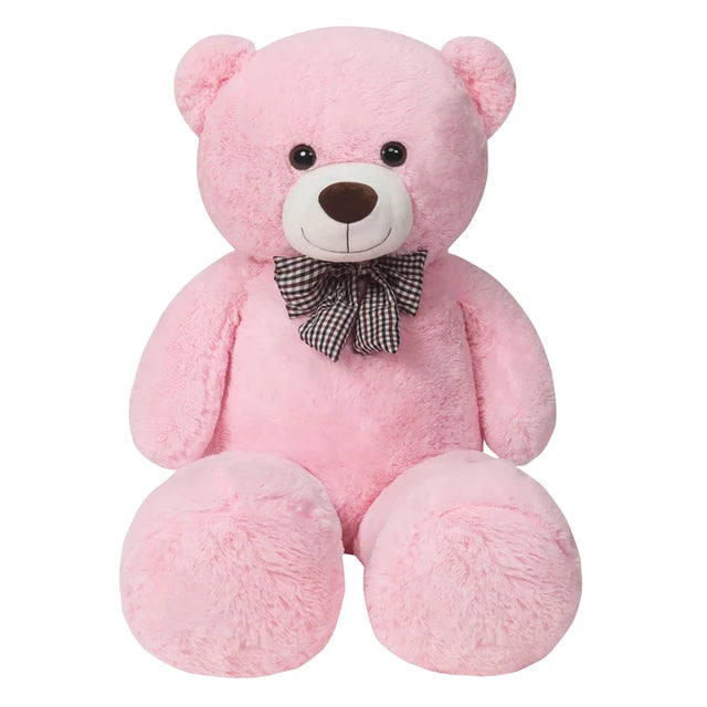 A pink soft teddy bear plush toy with a black checkered bow.