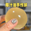 A hand holds a large, translucent yellow squishy stress relief toy.