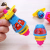 A hand holds a glowing spinning top toy with LED lights, showing various colored components.