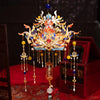 A detailed 3D metal phoenix crown model kit with gold and blue accents displayed on a red fabric background.