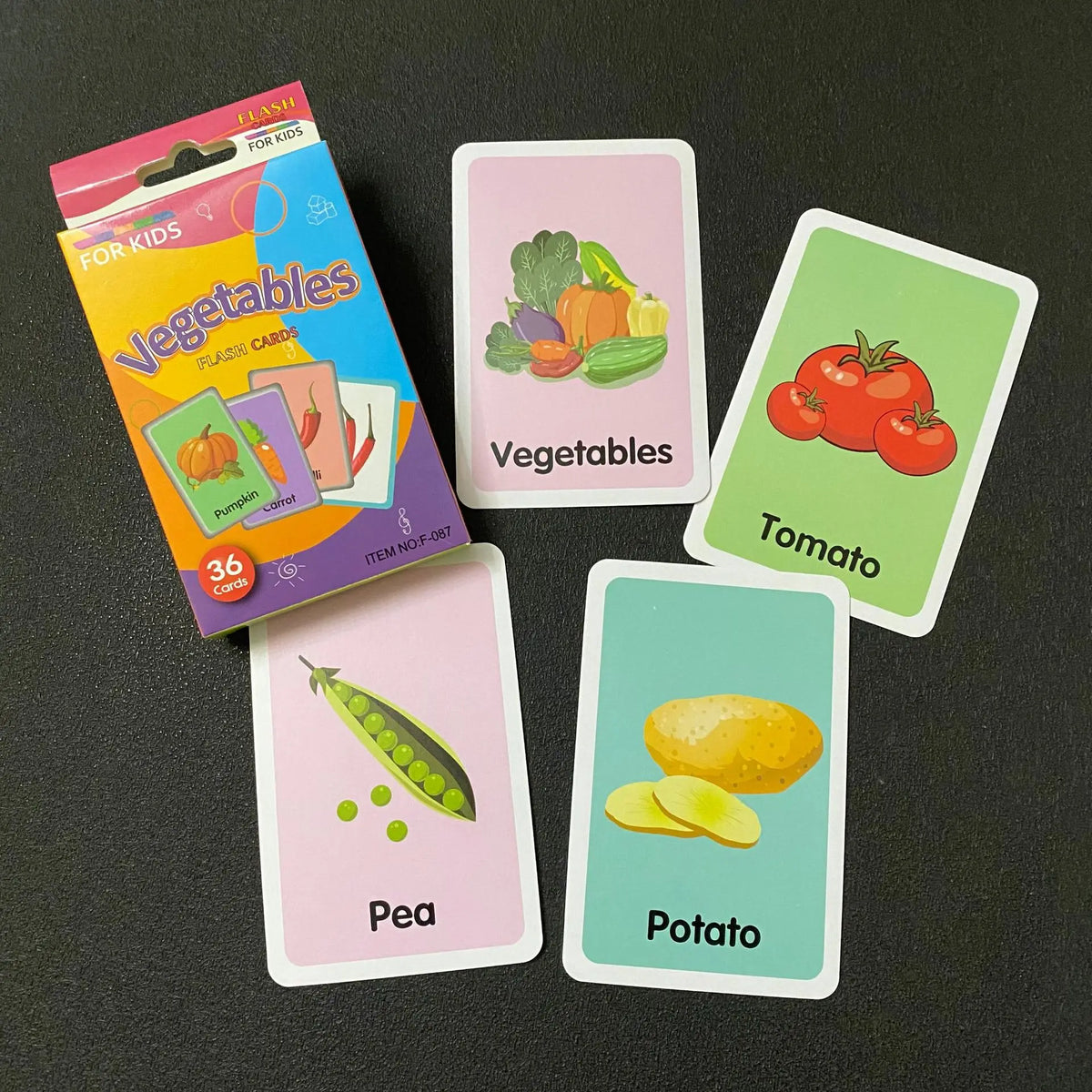 A collection of colorful flash cards featuring vegetables like tomatoes, potatoes, and peas.