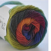 A ball of hand-dyed rainbow merino wool yarn, showing various shades of green, yellow, orange, red, purple, and blue.