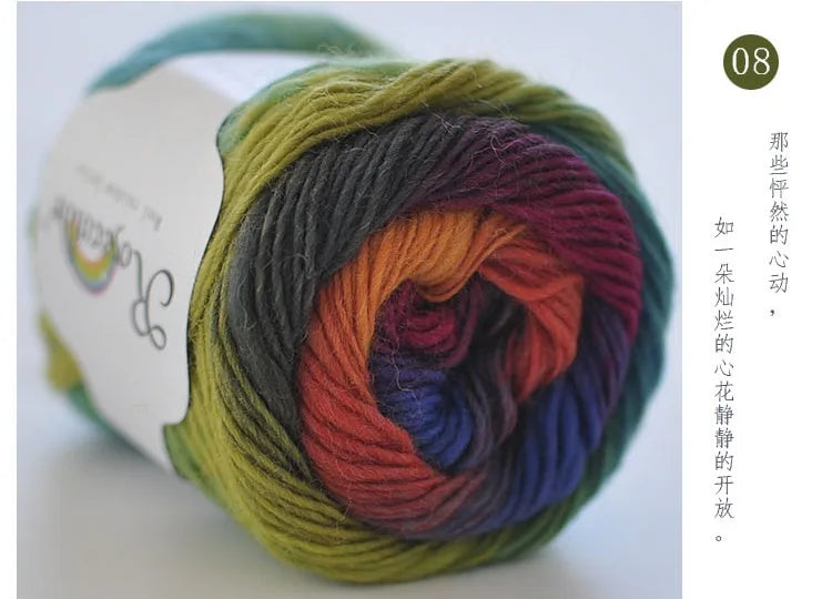 A ball of hand-dyed rainbow merino wool yarn, showing various shades of green, yellow, orange, red, purple, and blue.