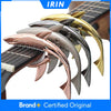 A set of metal shark guitar capos in various colors including gold, silver, and rose gold.