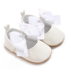 White lace-trimmed baby girl moccasin shoes with a white bow