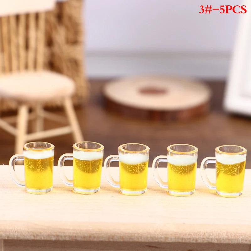 Five miniature resin wine bottles and cups filled with yellow liquid arranged on a wooden surface.