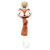An elephant pacifier holder featuring a brown fox head and a tan fabric strap with a white tip.