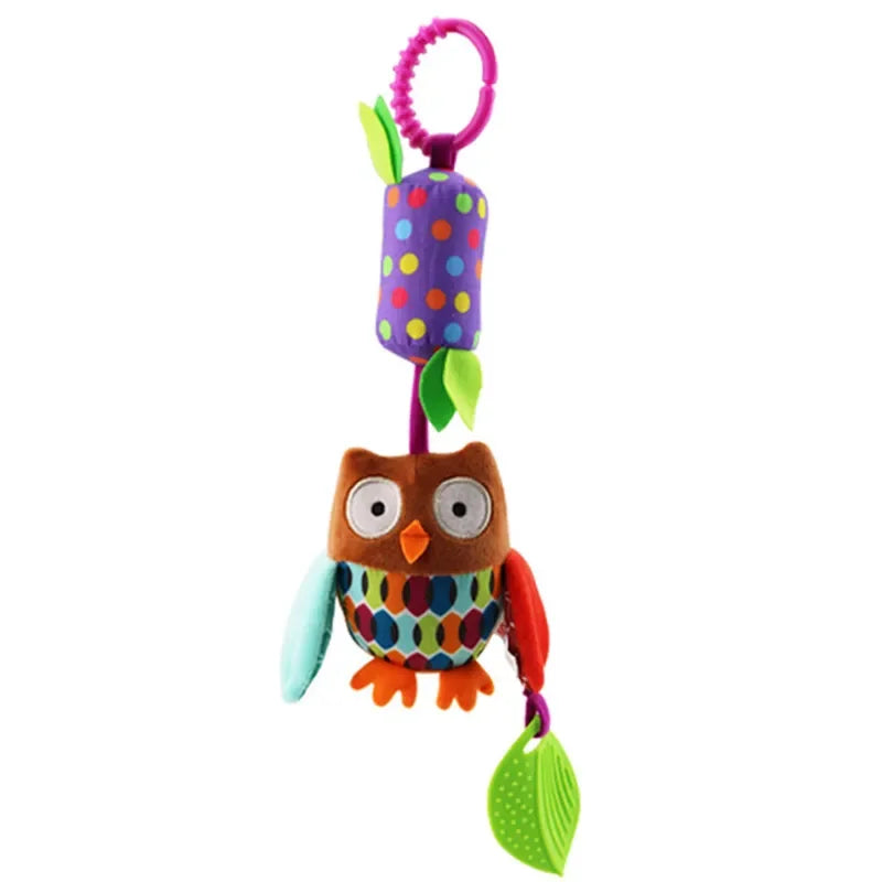 A colorful plush hanging toy shaped like a bird with a purple body and green leaves.