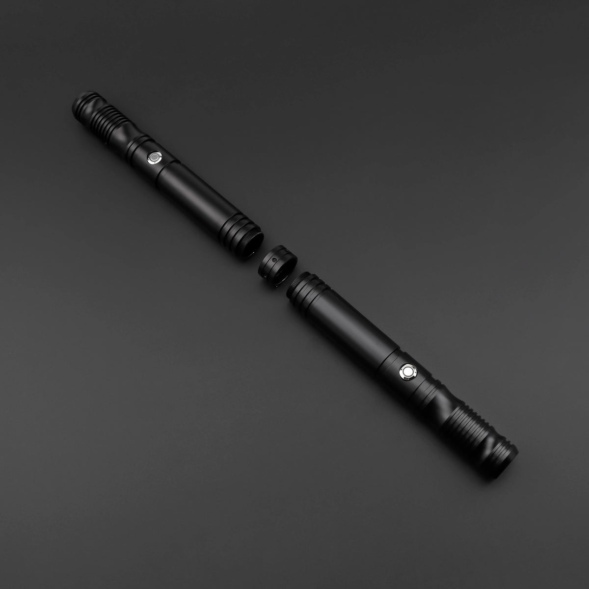 A black lightsaber staff with a metal hilt and decorative accents, shown diagonally on a dark surface.