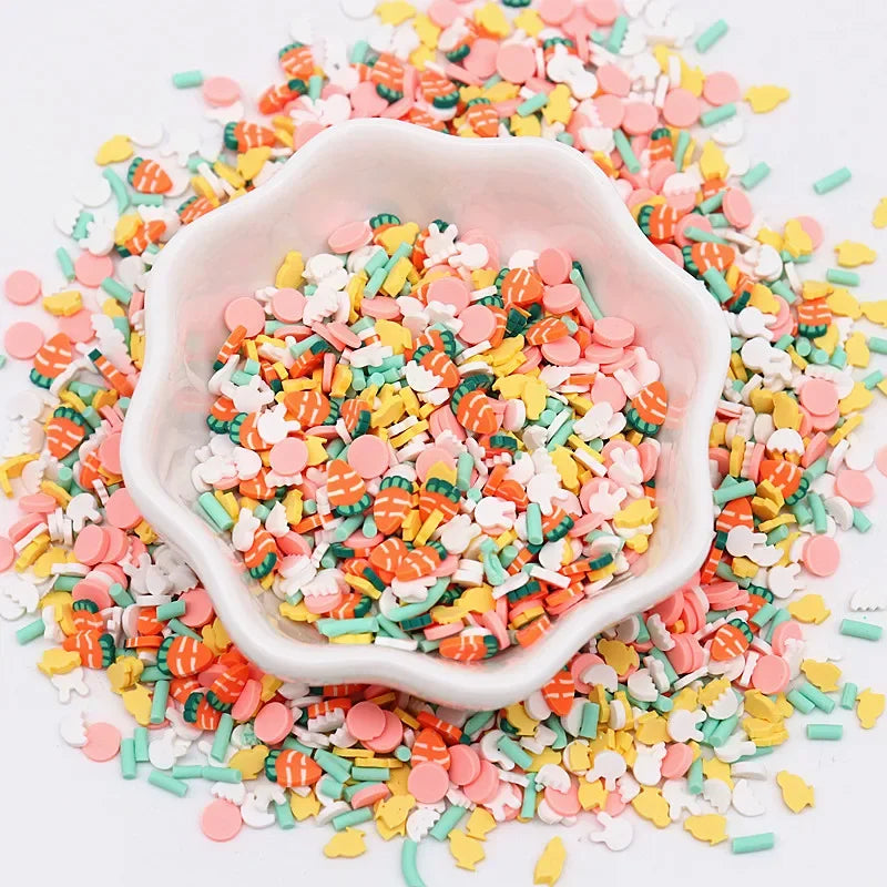 A white bowl filled with colorful polymer clay sprinkles mix for slime decor and DIY craft accents scattered on a white surfa