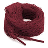A spool of deep red flat elastic silk lace shoelaces coiled on a white background.