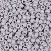 A close-up view of a 100-pack of small, round, white pony beads for jewelry making and craft projects.