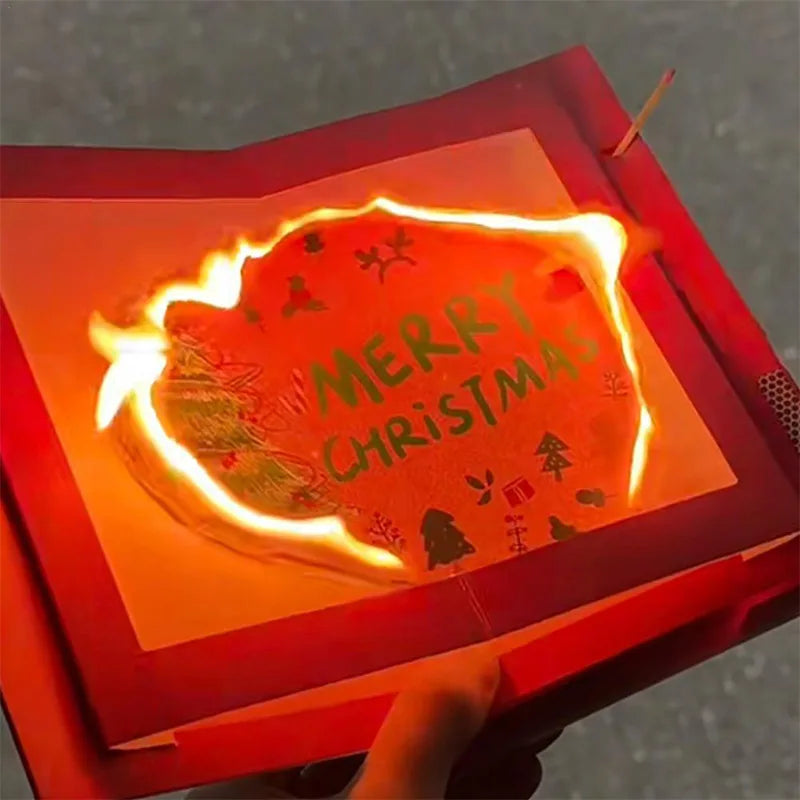 A glowing orange magic trick card inside a red box with the text Merry Christmas.