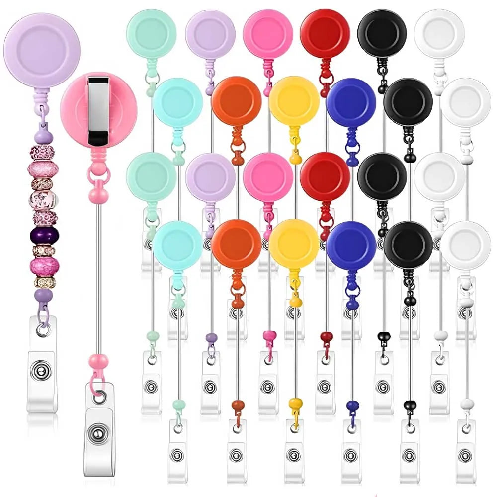 A collection of beadable badge reels with retractable clips in various colors and styles.