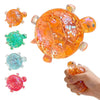 A collection of colorful squishy star turtle stress relief fidget balls, including orange, green, blue, and pink varieties.