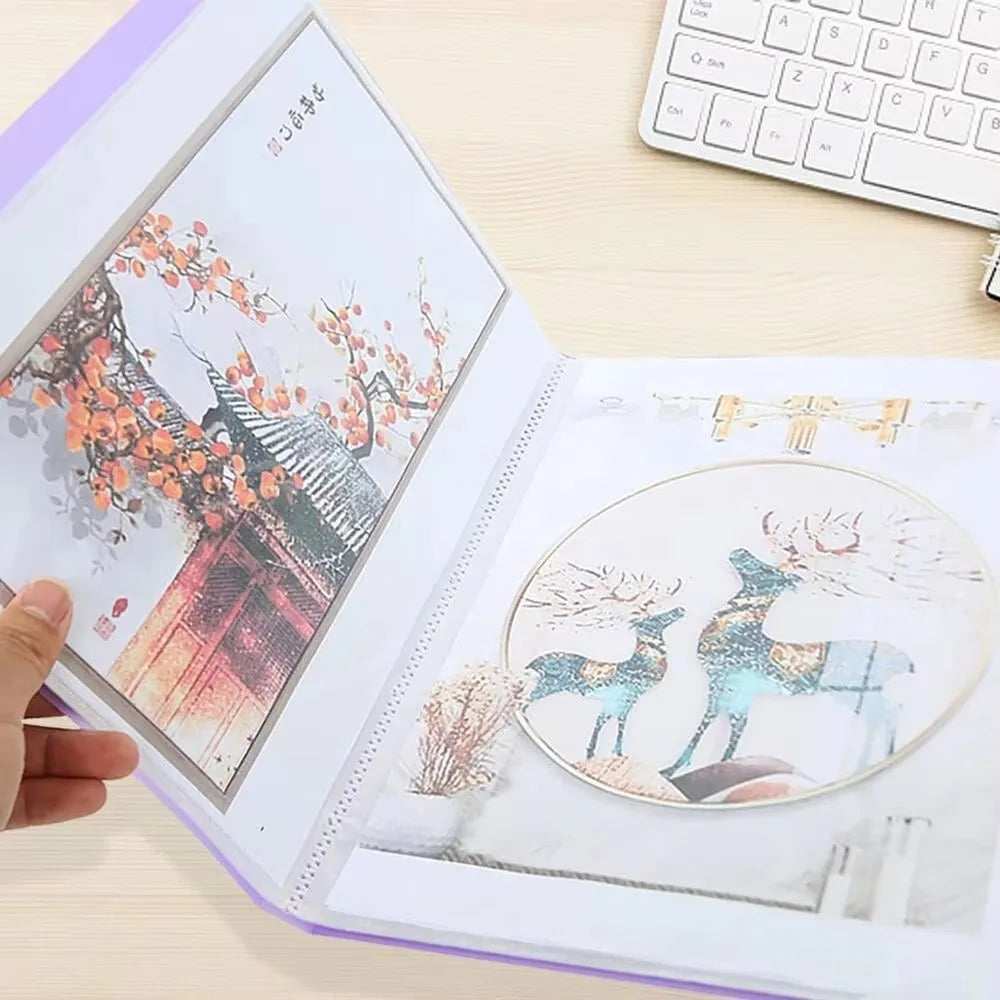 A transparent diamond painting storage album showing a detailed floral scene and a deer illustration.