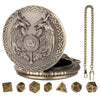 A silver Steampunk dragon pocket watch dice case with a lid and seven small gold dice.
