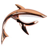 A metallic bronze shark-shaped guitar capo with a white plastic biting edge.