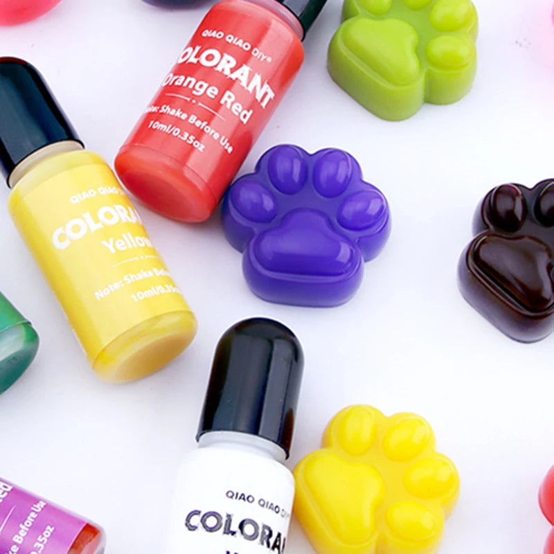 A collection of Qiao Qiao Colorant liquid pigments in various shades including orange red yellow and purple, displayed next t