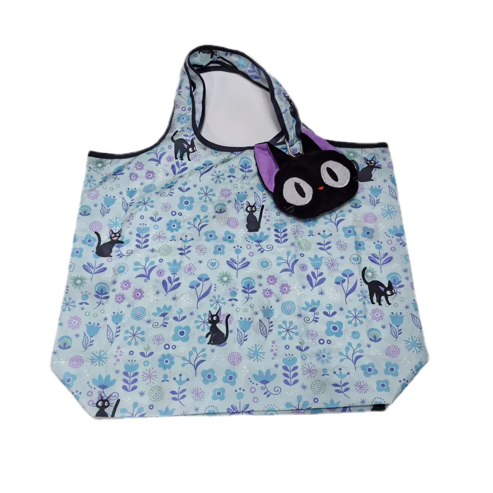 A light blue fabric bag featuring a pattern of various cats and floral designs, with a purple drawstring top.