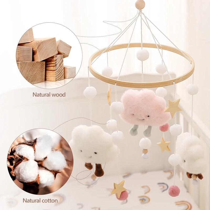 Wooden rattles and cotton cloud mobiles hanging from a wire structure for an infant crib