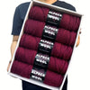 A pack of five skeins of deep burgundy alpaca wool yarn for knitting and crochet projects.