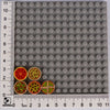 A grid of grey building blocks with various food shapes like pizza and cake visible.