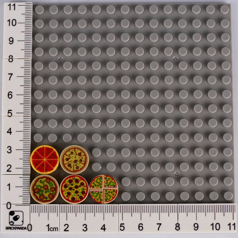 A grid of grey building blocks with various food shapes like pizza and cake visible.
