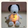 A white plush toy resembling Snoopy with an illuminated chest light for night comfort.