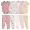 Ensemble de bodys et pantalons pour nouveau-nés, roses, blancs et crème, avec motifs de cœurs et points jaunes.