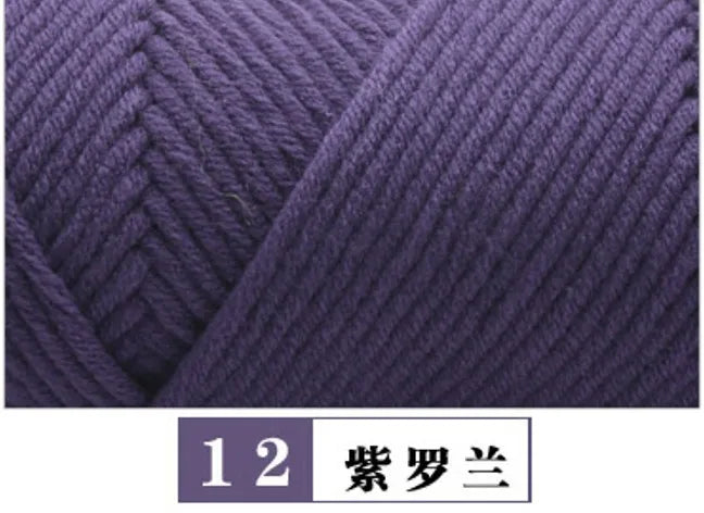 A close-up view of dark purple premium milk cotton yarn showing the texture and twist for knitting.