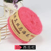 A ball of bright pink silk mohair blended yarn for knitting, displayed next to a gold wire rack.