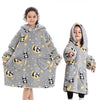 A young girl models a gray fuzzy flannel hoodie sweater with yellow stars and panda patterns.
