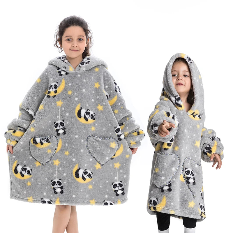 A young girl models a gray fuzzy flannel hoodie sweater with yellow stars and panda patterns.