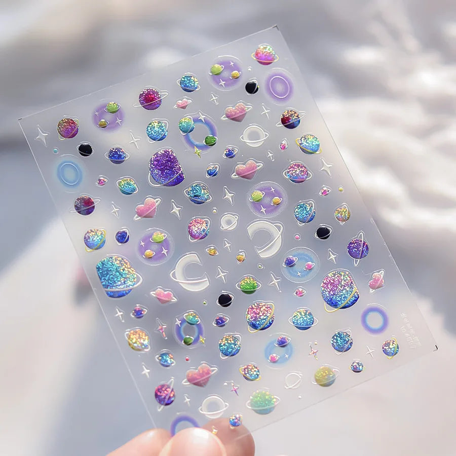 A sheet of 5D Bronzing Gothic Nail Art stickers with various iridescent and glittery designs