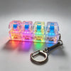 A set of four translucent LED light-up keycap fidget flashlights attached to a silver keychain.